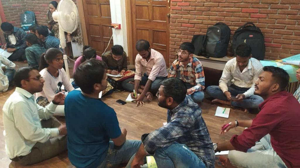 workshop participants sitting in a circle during an activity