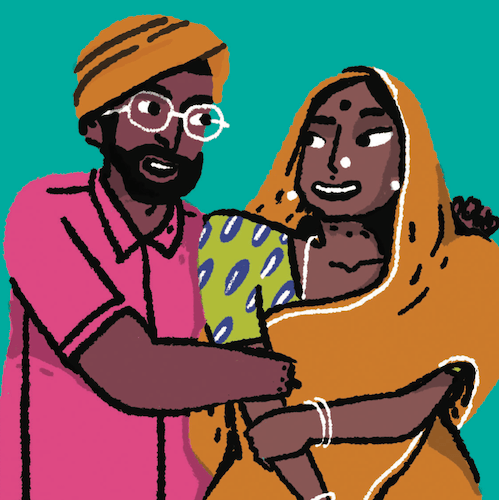 A person with an orange turban, pick shirt, beard, and white rimmed glasses hugs another person who is wearing an orange saree, headscarf, and bangles. They are both smiling.